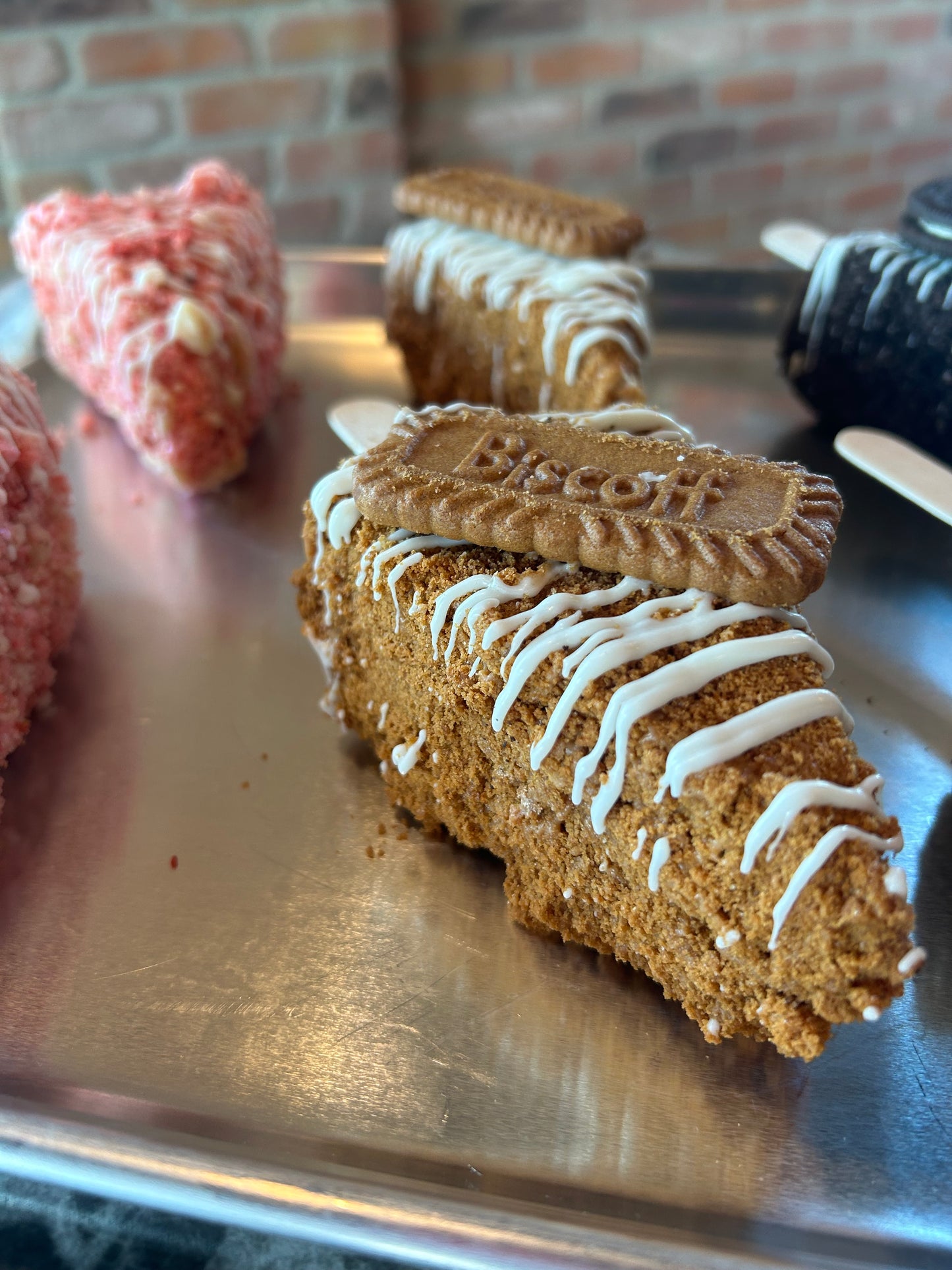 1 Large New York Style Slice Biscoff- Chocolate covered Cheesecake on a stick